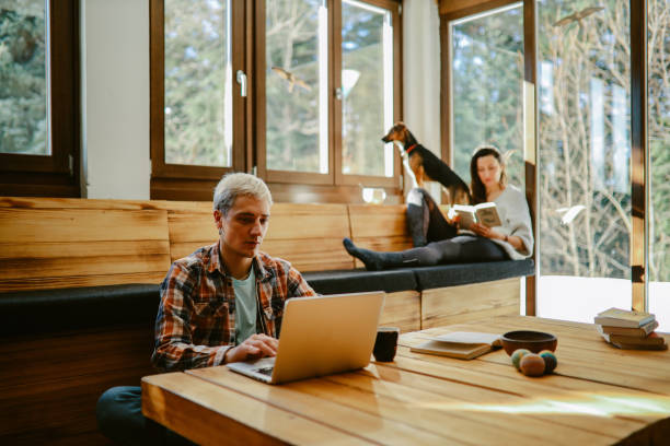 young people doing remote work from the mountain cabin