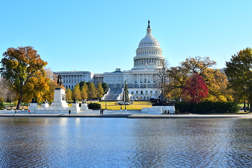 United States Capitol building and reflecting pool are seen on an autumn day in Washington, D. C.