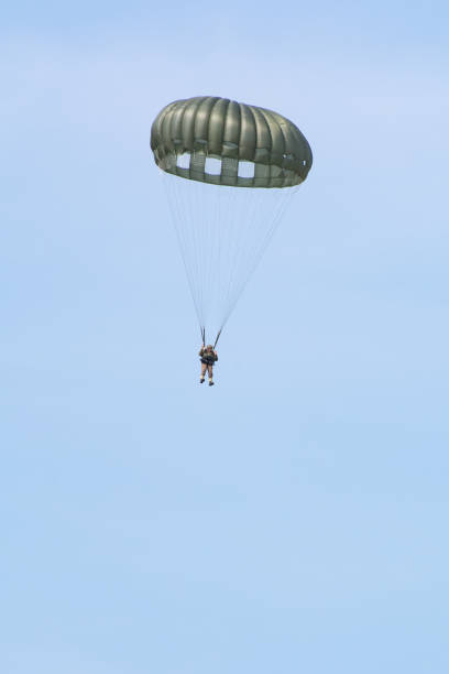 WW2 Soldier Jumping from plane with parachute WW2 Soldier jumps from C-47 Vintage aircraft plane during a world war re-enactment and display in  Kent, United Kingdom.

1st July 2018 operation market garden stock pictures, royalty-free photos & images