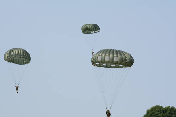 Skydiver in Action, A skydiver gliding through the blue sky with a fully deployed parachute, showcasing the thrill and freedom of airborne adventure.