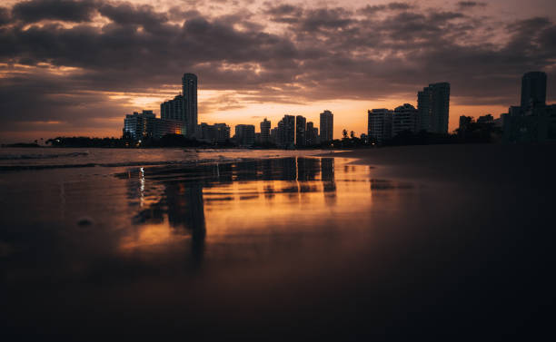 Sunset on the beach with a modern skyscrapers  in a background