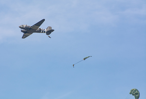 WW2 Soldier jumps from C-47 Vintage aircraft plane during a world war re-enactment and display in  Kent, United Kingdom.

1st July 2018