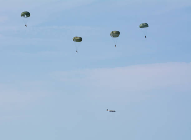 WW2 Soldier Jumping from plane with parachute WW2 Soldier jumps from C-47 Vintage aircraft plane during a world war re-enactment and display in  Kent, United Kingdom.

1st July 2018 operation market garden stock pictures, royalty-free photos & images