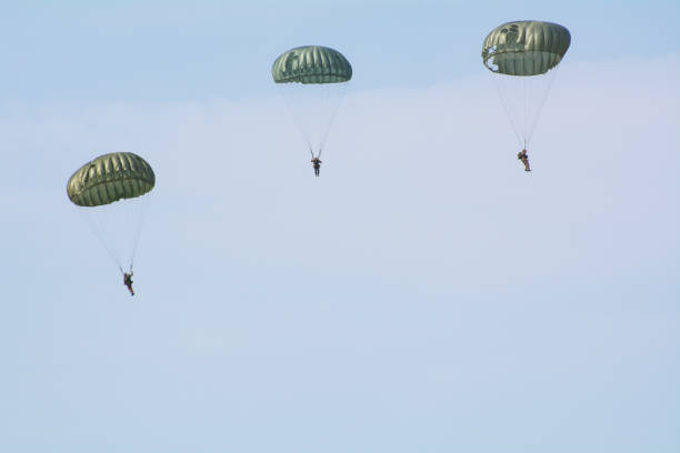 WW2 Soldier jumps from C-47 Vintage aircraft plane during a world war re-enactment and display in  Kent, United Kingdom.

1st July 2018