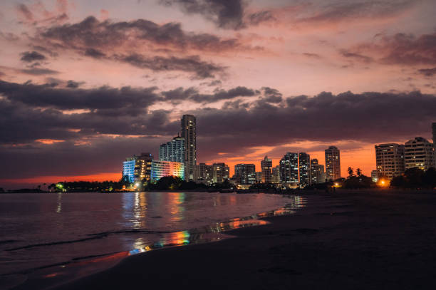 Twilight on the beach with a modern skyscrapers  in the background.\nCartagena, Colombia.