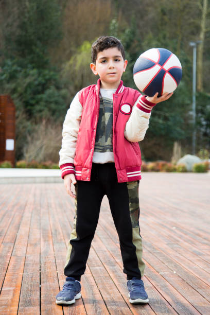 Kid is playing basketball