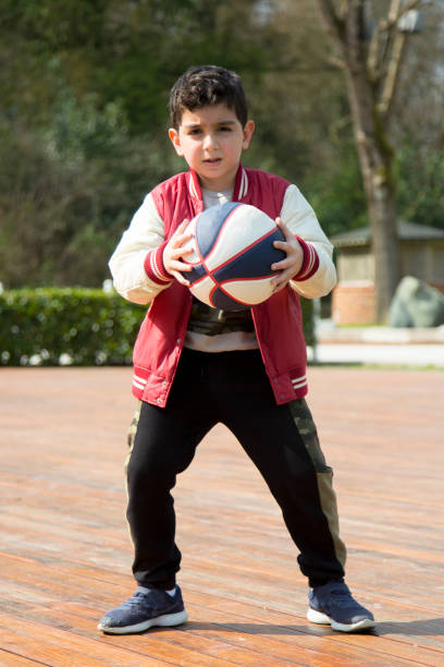 istock Kid is playing basketball 1385837832