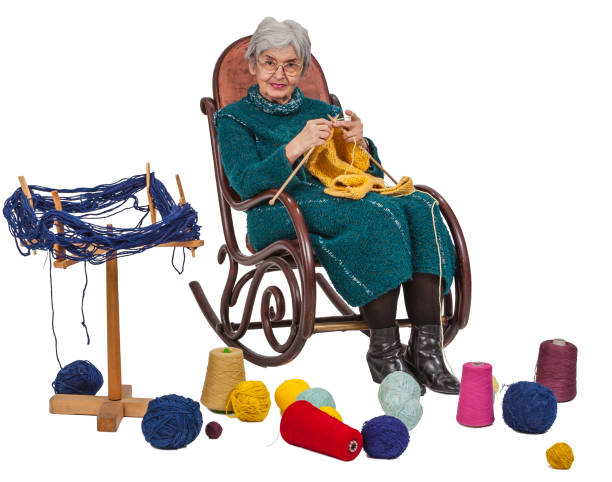Image of an old woman sitting on a rocker and knitting, isolated against a white background.
