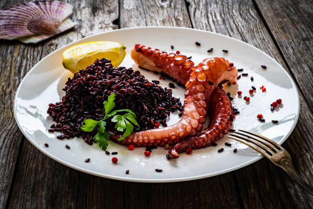 istock Boiled octopus and vegetables on wooden table 1385841539