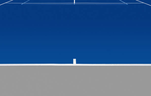 blue tennis court and tan colored baseline area. No net.  Vanishing perspective