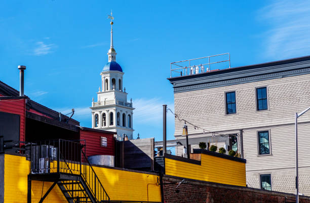 Harvard Square - Roof top view - Cambridge Massachusetts View across roof tops of Harvard Square buildings. Tower with cupola in background. cambridge massachusetts stock pictures, royalty-free photos & images