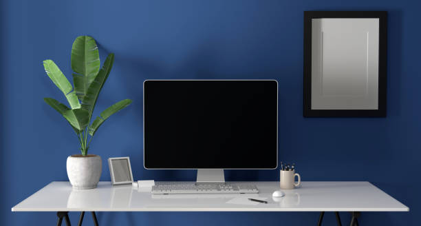 istock laptop on a desk - mock up 1385845544