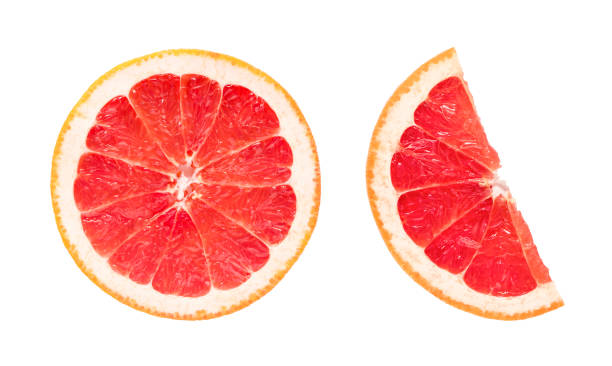 istock Grapefruit slice isolated. Fresh pink grapefruit slices on white. Circle and half. Flat lay. Top view. 1385847274
