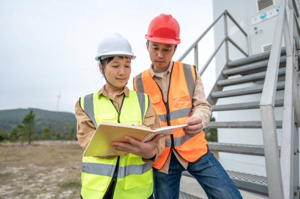 istock An Asian male engineer and a female engineer used a notebook to discuss data next to the wind turbine and scientifically analyze the state of the equipment 1385862871