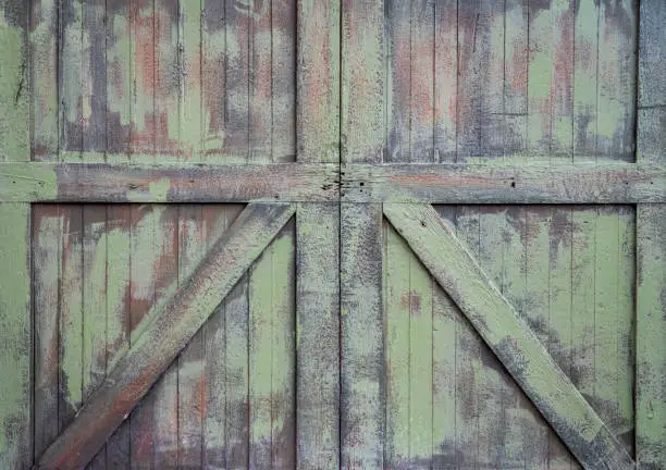 rustic grunge wooden gate painted green, retro background and texture