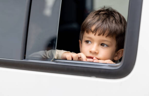 istock Boy in a car looking through the open window 1385871598