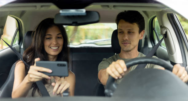 istock Happy couple checking the GPS before going on a road trip 1385872135