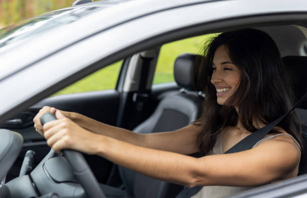 istock Happy woman driving a car 1385872139