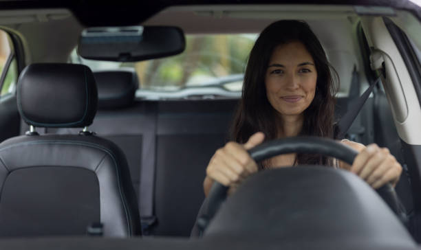 istock Happy woman driving a car 1385872144