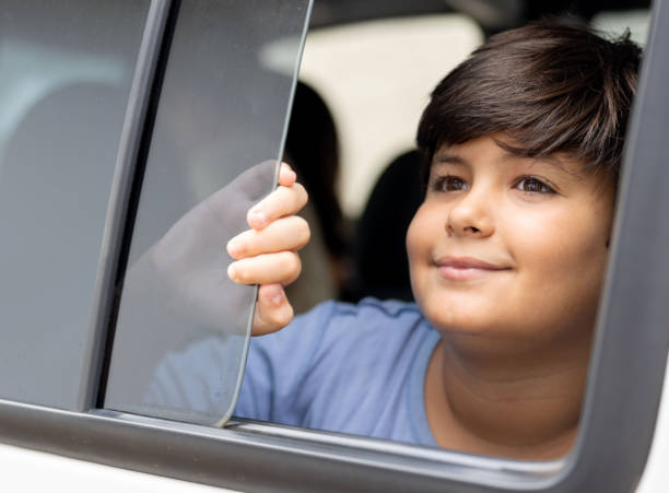 istock Boy in a car looking through the open window 1385872204