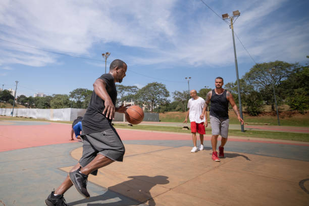 istock playing basketball in the park 1385872410