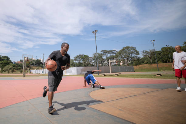 istock playing basketball in the park 1385872411