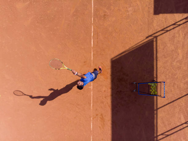 istock young man playing tennis 1385876086