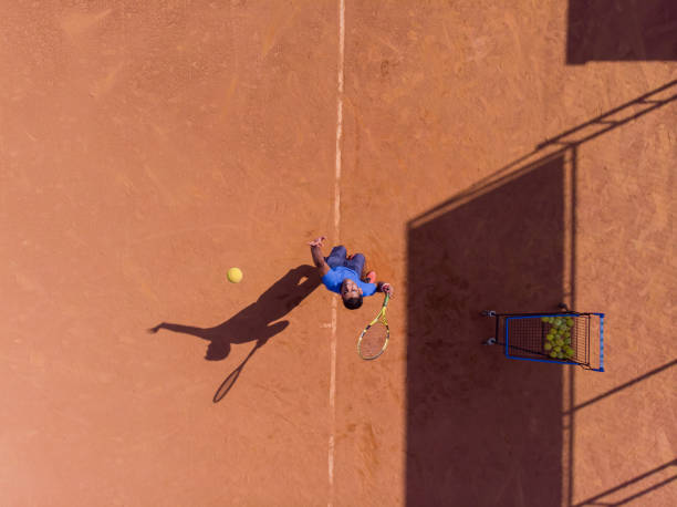 istock young man playing tennis 1385876087