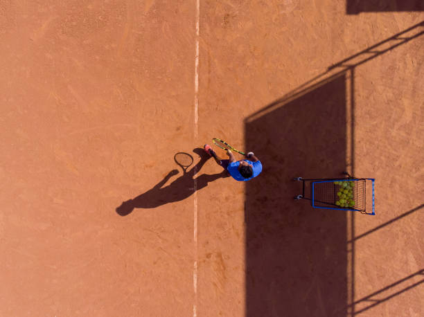 istock young man playing tennis 1385876269
