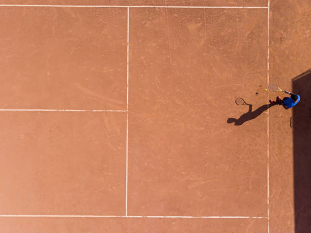 istock young man playing tennis 1385876271