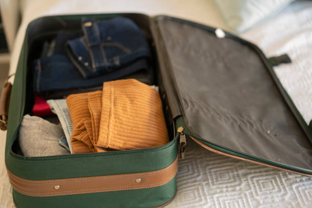 istock Open hand luggage on  bed at hotel room 1385877209