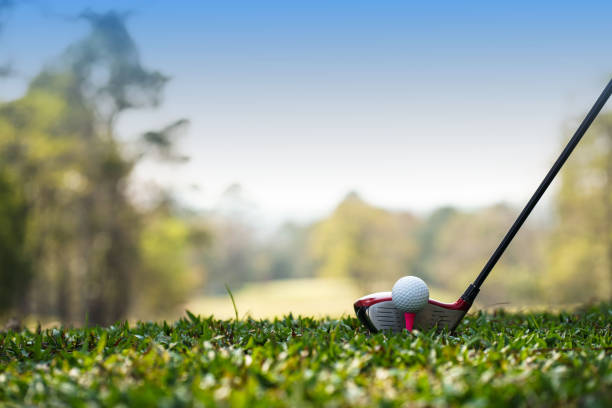 Golf clubs and golf balls on a green lawn in a beautiful golf course with morning sunshine. Golf clubs and golf balls on a green lawn in a beautiful golf course with morning sunshine. golf ball on green grass ready to hit on golf course background. Golf stock pictures, royalty-free photos & images