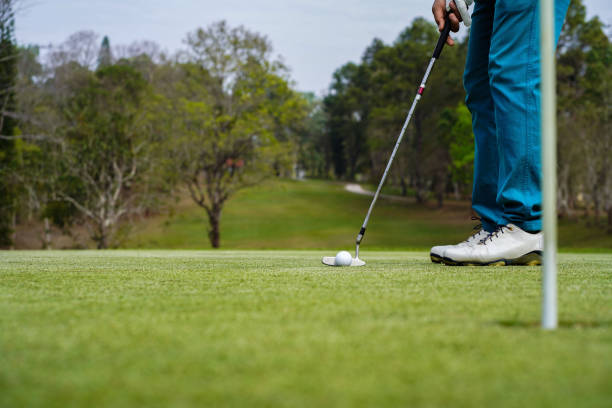 istock Golfer playing golf in the evening golf course, on sun set evening time. Man playing golf on a golf course in the sun 1385878119