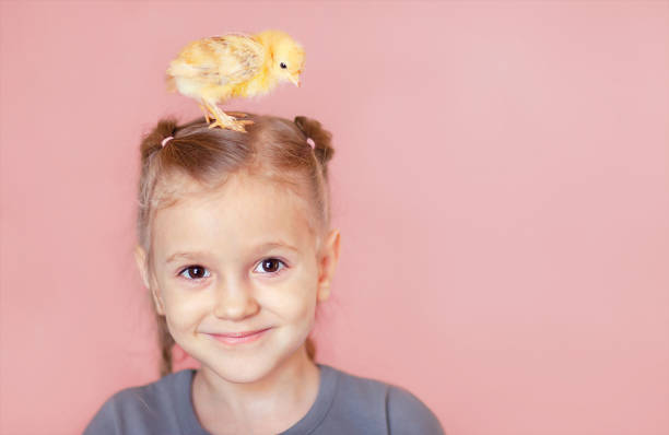 istock babygirl with a chicken on her head 1385878295