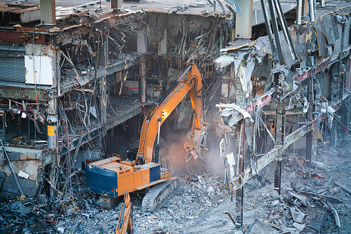 Machinery vehicle demolition site tearing down a building