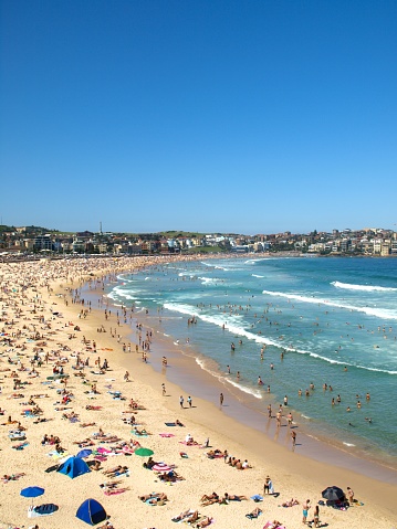 Crowds of beachgoers at Bondi Beach, Sydney.  This image was taken before the Covid-19 pandemic on an afternoon in summer.