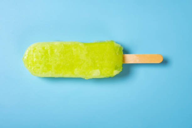 istock top view fresh green popsicle on a blue background 1385884140