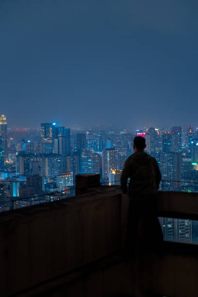 istock A man who looks at the scenery at high altitude at night 1385886488