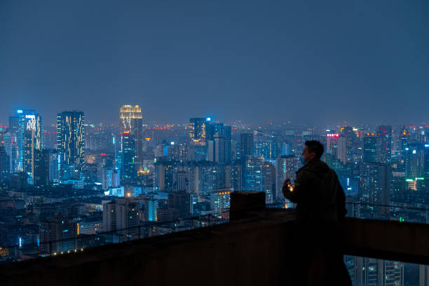 istock A man who looks at the scenery at high altitude at night 1385886489