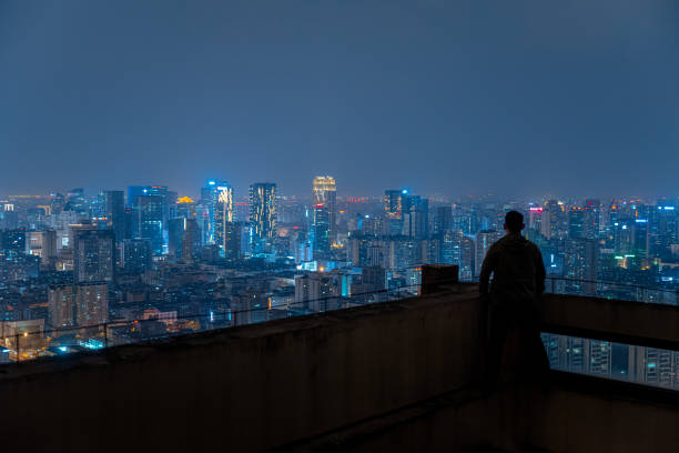 istock A man who looks at the scenery at high altitude at night 1385886495