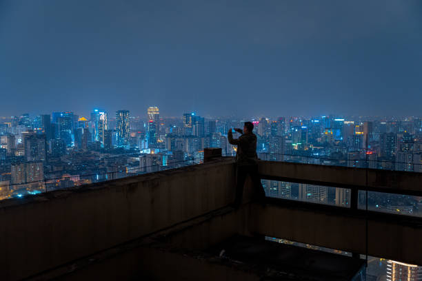 istock A man who shoots scenery with his mobile phone at high altitude at night 1385886510