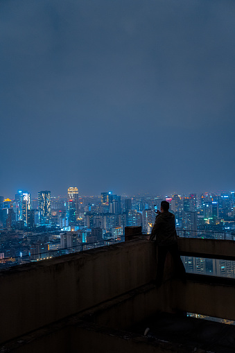 A man who looks at the scenery at high altitude at night