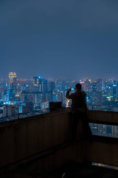istock A man who shoots scenery with his mobile phone at high altitude at night 1385886516
