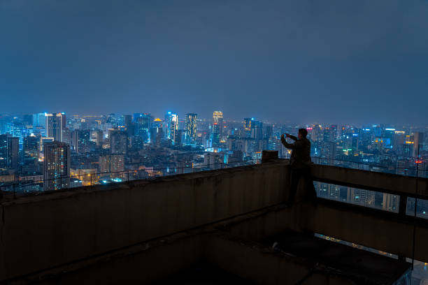 istock A man who shoots scenery with his mobile phone at high altitude at night 1385886524
