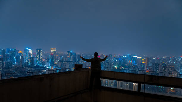 istock A man who looks at the scenery at high altitude at night 1385886550