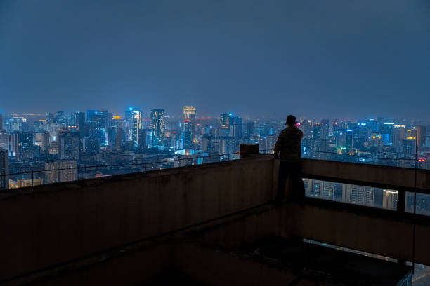 istock A man who looks at the scenery at high altitude at night 1385886551