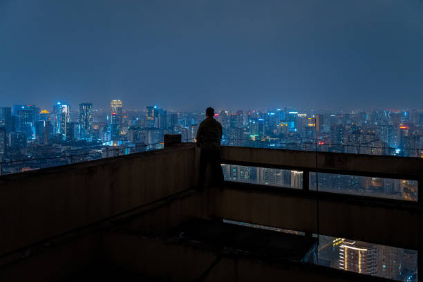 istock A man who looks at the scenery at high altitude at night 1385886561