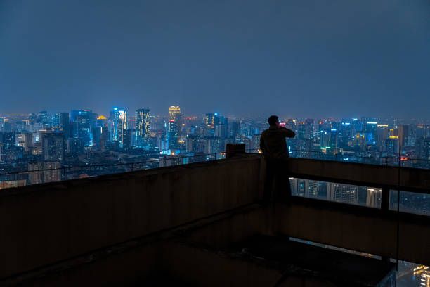 istock A man who looks at the scenery at high altitude at night 1385886563