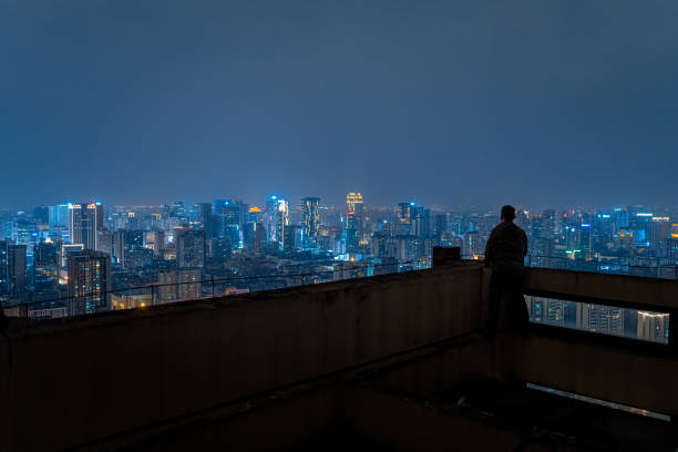 istock A man who looks at the scenery at high altitude at night 1385886568