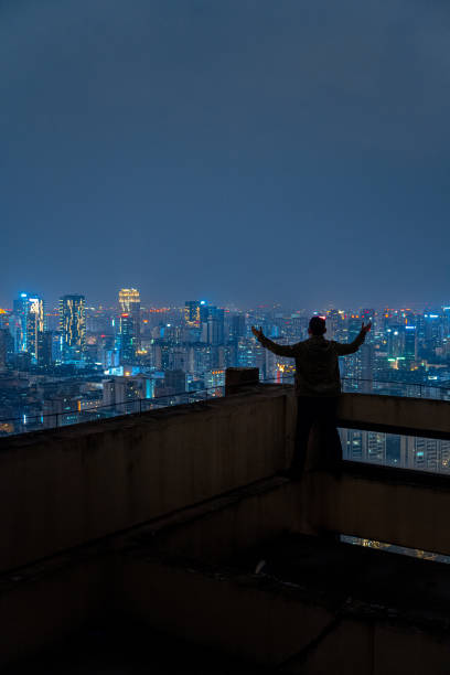 istock A man who looks at the scenery at high altitude at night 1385886572